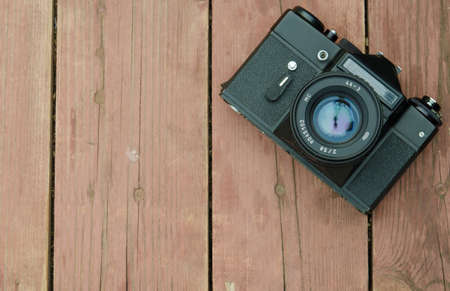 Vintage camera while wearing the  lens rests on a wooden backgroundの写真素材