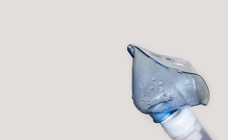 woman using inhaler nebulizer for respiratory diseasesの写真素材