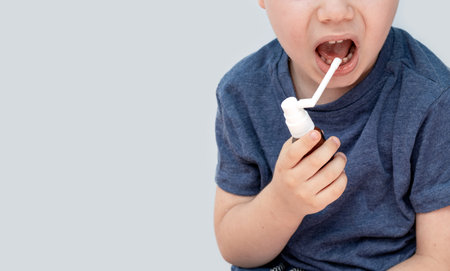 sore throat treatment concept half face kid child boyの写真素材