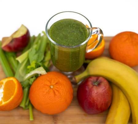 healthy smoothie in glass and fruits all around on wooden boardの写真素材