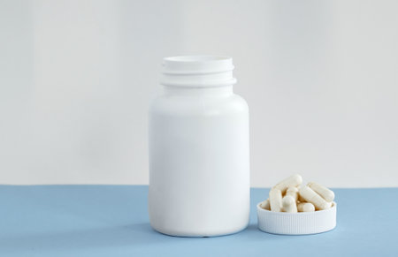 white pills bottle with vitamin c capsules with stethoscope and measure tapeの写真素材