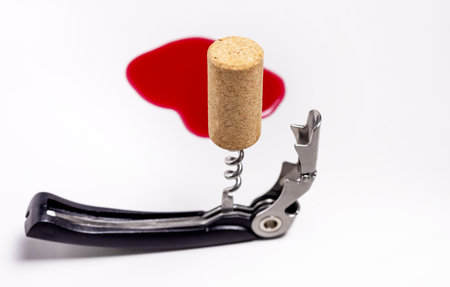 red wine poured on surface heart shape, cork and corkscrew, empty glassの写真素材