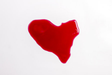 red wine poured on surface heart shape, cork and corkscrew, empty glassの写真素材