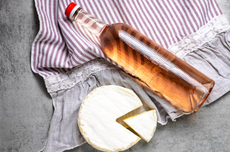 composition from rose wine bottle,glass, round cheeseの写真素材