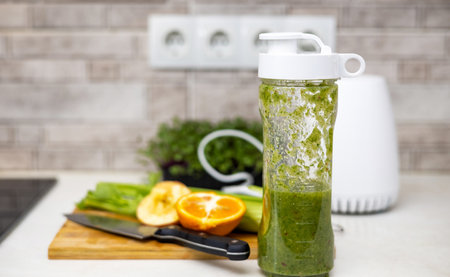 woman do healthy smoothie at kitchen, weight loss concept, measure tapeの写真素材