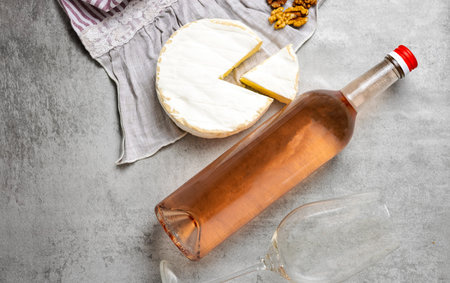 composition from rose wine bottle,glass, round cheeseの写真素材