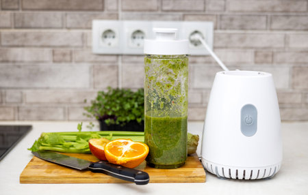 woman do healthy smoothie at kitchen, weight loss concept, measure tapeの写真素材