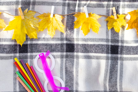 autumn fall leaves on paper with colorful pencils glasses frame mockup freeの写真素材