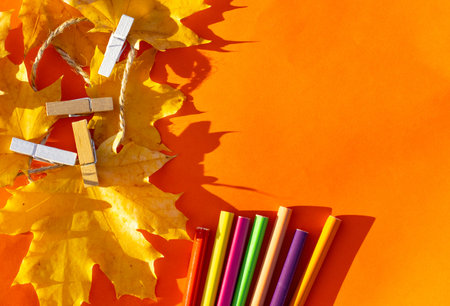 autumn fall leaves on paper with colorful pencils glasses frame mockup freeの写真素材
