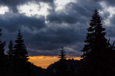 Clear sky at the horizon creates interesting contrast at sunsetの写真素材