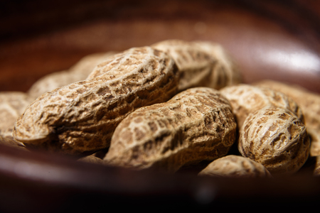 Peanuts in wooden dish closeup macroの写真素材