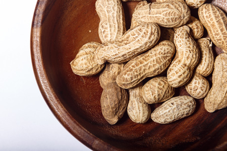 Peanuts in wooden dish closeup macroの写真素材