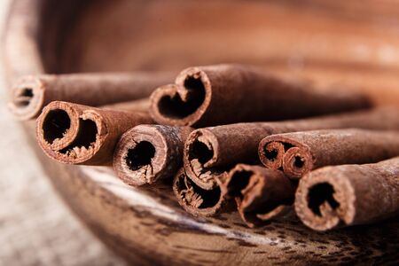 Cinnamon sticks canella on wooden background close-up macro
