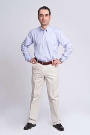 Full length portrait businessman in suit isolated over gray backgroundの写真素材