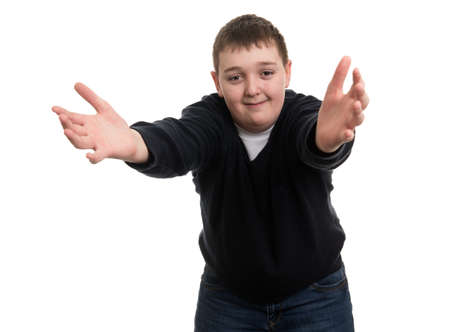 Funny Caucasian boy smiles grimacing and waving hands next to faceの写真素材