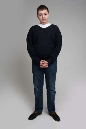 young casual man full body in a gray backgroundの写真素材