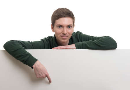 A portrait of a young asian man holding a blank banner isolated on white background. peeping from behindの写真素材