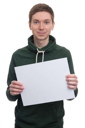 portrait of handsome young man holding blank billboard over white backgroundの写真素材