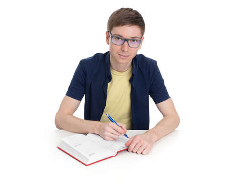 The student sits at a table and writes isolated on white background
