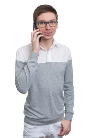 young man with glasses talking on the phone isolatedの写真素材