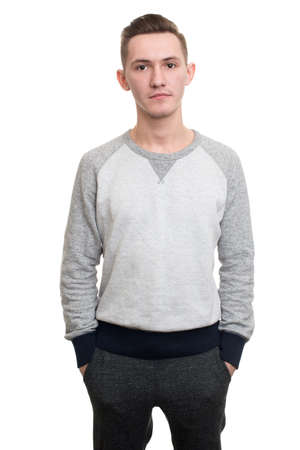 Casual young man looking at camera with arms crossed and satisfactionの写真素材