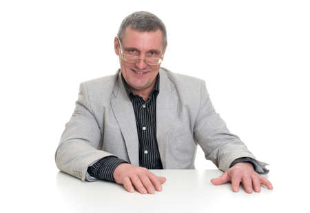 Successful mature businessman looking at camera  at work in officeの写真素材