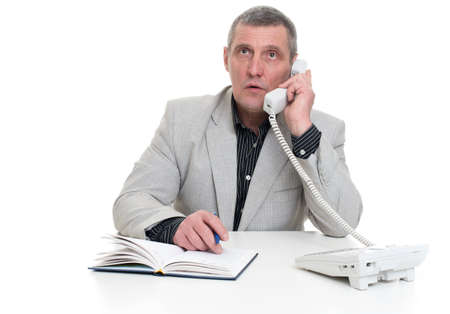 older business man sitting at the table and isolatedの写真素材
