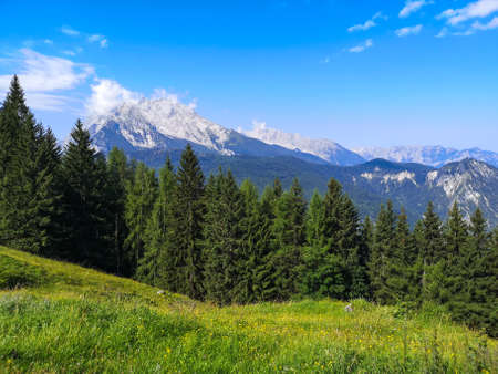 View on the Berchtesgaden Alps mountain peaks covered by snow in clouds - Germanyの写真素材