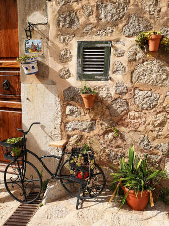 Medieval streets of Valldemossa decorated with plants and steel bike - Mallorcaの写真素材