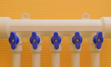 Polypropylene pipe to the collector on a background of yellow wallの写真素材