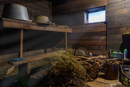 scattered things in a wooden shed with windowの写真素材