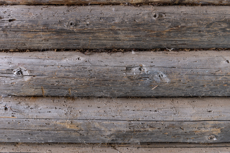 old wall of the rounded wooden logsの写真素材