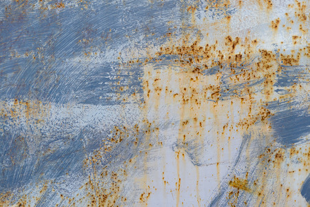 old painted metal surface with rust tracesの写真素材