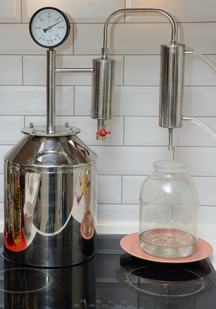 Making moonshine by distilling in the kitchenの写真素材