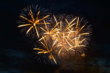 yellow fireworks fireworks in the dark evening skyの写真素材