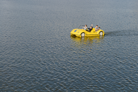 June 2, 2016: Some cheerful teenagers ride a catamaran. Cheboksary. Russia.のeditorial素材