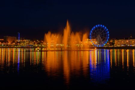 May 4, 2019: Evening cityscape with a bay, a fountain, a ferris wheel. Cheboksary. Russia.のeditorial素材