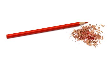 red sharpened pencil with sawdust on a white backgroundの写真素材