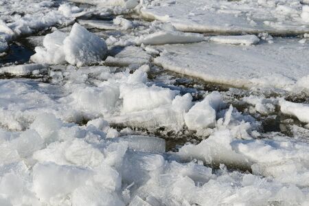 Photo of an ice drift on a river with cracked ice