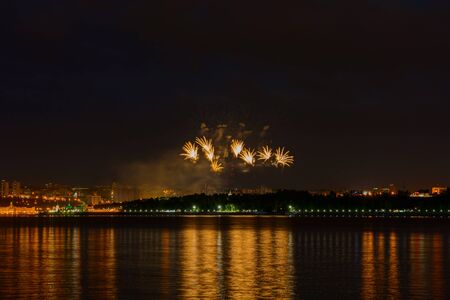 June 23, 2019: Fireworks over the night city by the river. Cheboksary. Russia.のeditorial素材