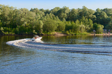 July 4, 2020: Photo of a motor boat floating on the river. Russia. Volga river in the vicinity of Cheboksary.のeditorial素材