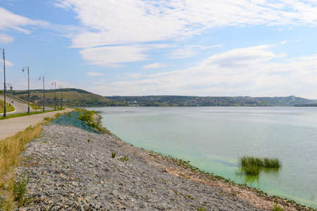 River embankment with paved road and lightsの写真素材