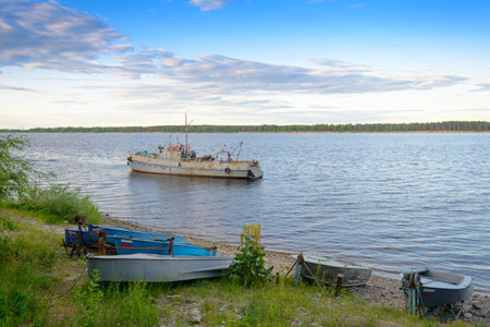 June 28, 2020: A small boat station with old boats on a wooded shore. Chuvashia. Russia.のeditorial素材