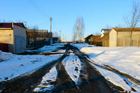 March 1, 2017: Village street with melting snow on the road. The village of Sugaikasy. Russia.のeditorial素材
