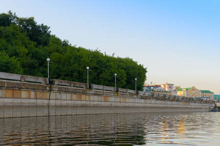 Concrete bank of an artificial reservoir with lanterns and forestの写真素材
