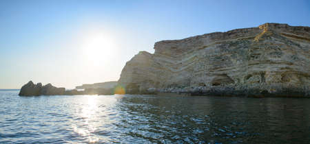 The sea shore with steep cliffs on a summer eveningの写真素材