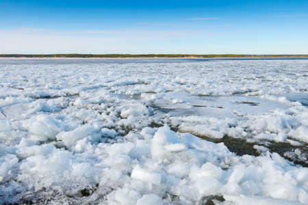 Pieces of ice float on the river during the ice driftの写真素材