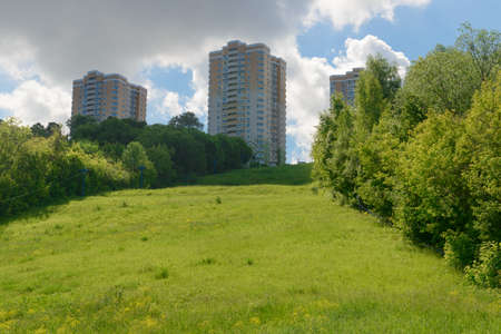 High multi-storey residential buildings on top of a green hillの写真素材