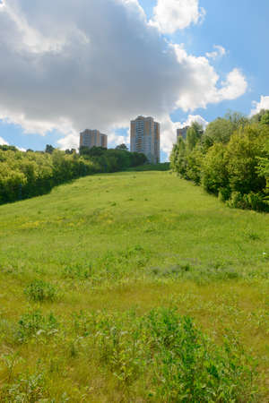 High multi-storey residential buildings on top of a green hillの写真素材