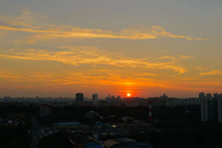 Evening panorama of the city with the setting sunの写真素材